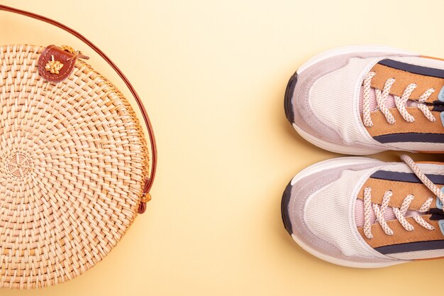 Sneakers and rattan bag. Travel concept. Flat lay