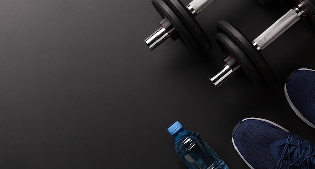 Sneakers water and dumbbells Sport fitness and healthy lifestyle