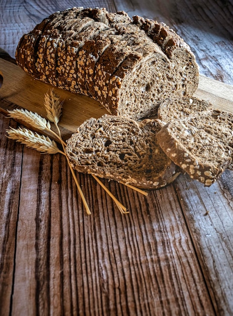 Sneetjes vers brood en korenaren op een rustieke tafel