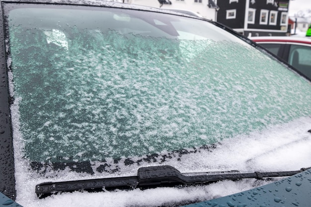 Sneeuwvlok bedekt op de voorruit in de winter