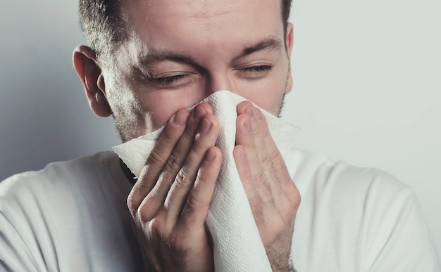 Sneezing young man