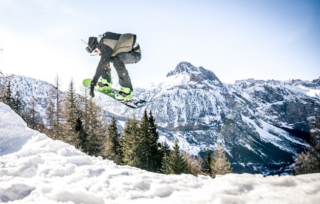 Snoboarder performing tricks on the snow