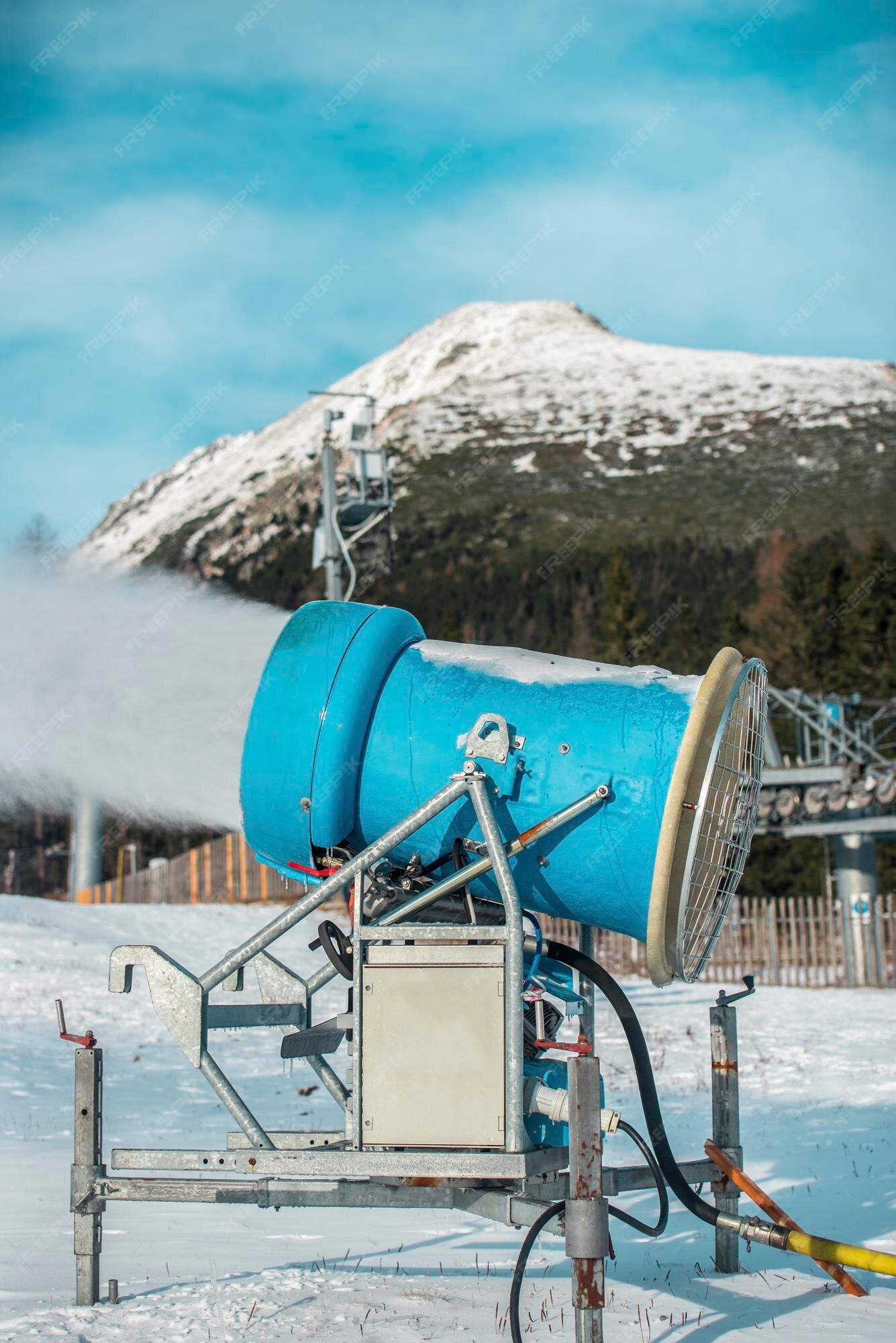 Premium Photo  Snow cannon in winter mountains. snow-gun spraying  artificial ice crystals. machine making snow.