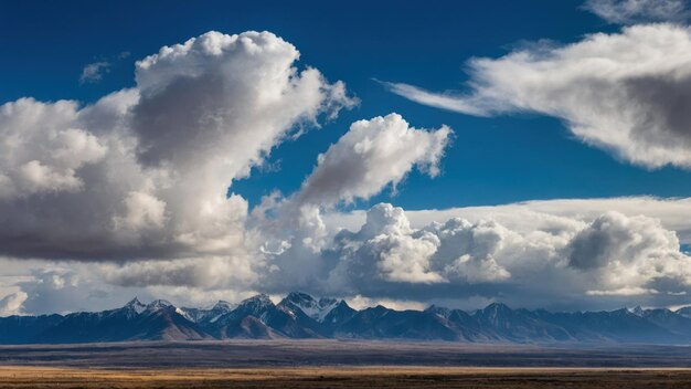 Photo snow capped mountain above the clouds under a blue sky