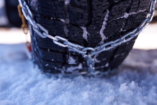 Snow chain on a wheel in deep snow in winter