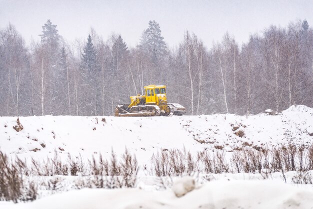 Snow clearing. Tractor clears the way after heavy snowfall.