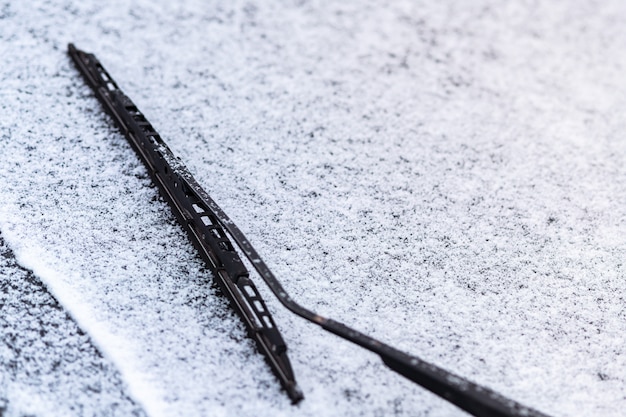 Snow covered car window with wipers