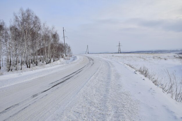 Snow covered dirt road in winter Russia