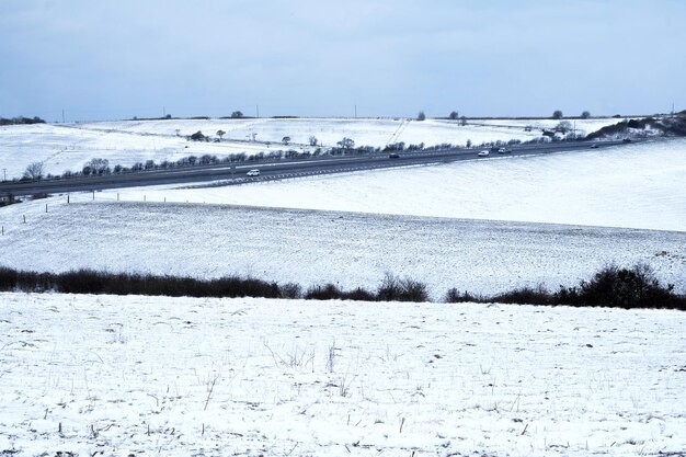 Snow covered field against sky