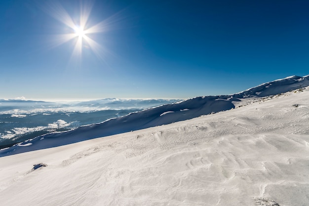 Snow covered hills in winter mountains