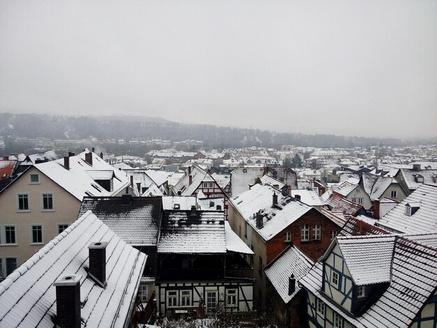 Snow covered houses against clear sky in marburg town