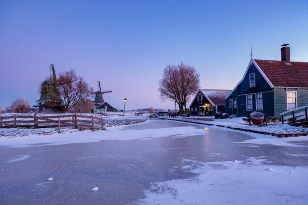 Snow covered houses and buildings against sky