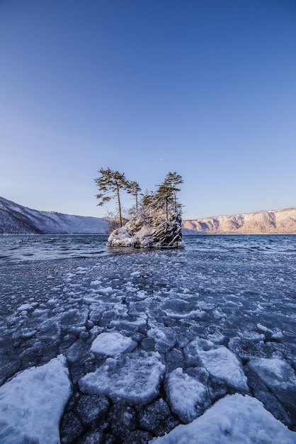 Snow covered landscape against clear sky