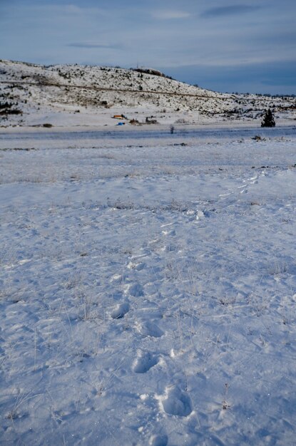 Snow covered landscape against sky