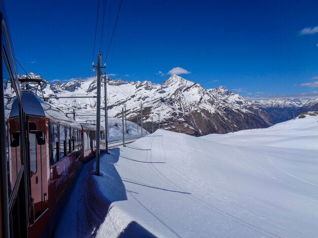 Snow covered mountains against blue sky