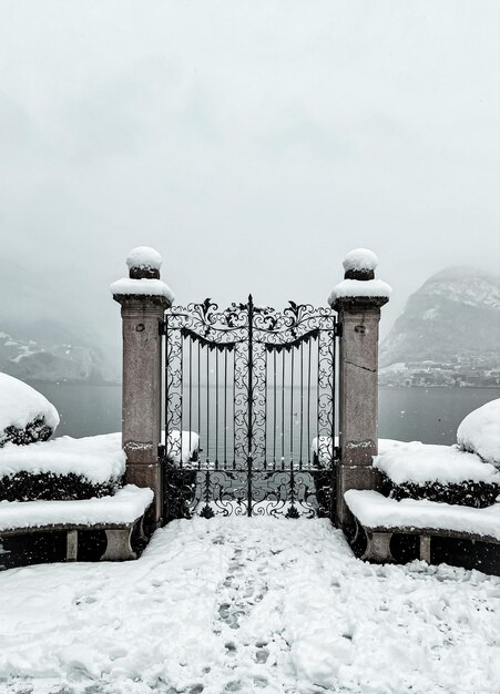 snow covered railing against sky