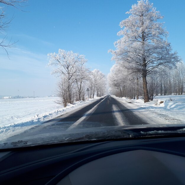 Snow covered road seen through car windshield