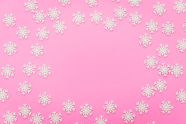 snow flake arrange flat lay on pink color background