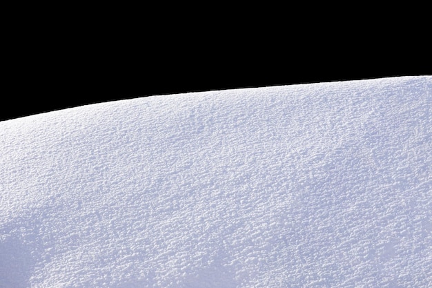 Snow on a hill with a black background