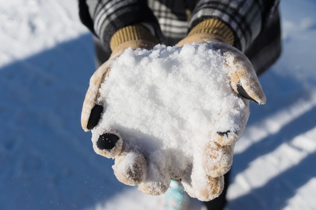 雪は女性の手にある。クローズアップ、屋外