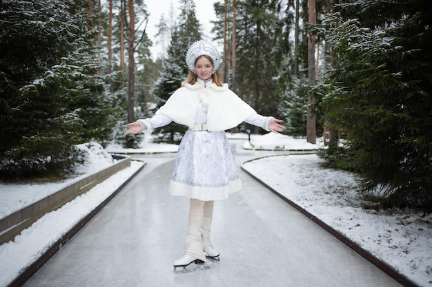 Snow maiden figure skater a cute young blonde in a white snow maiden costume with a kokoshnik skatin