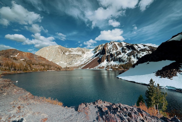 Snow mountain cloud and lake with reflections in Yosemite.