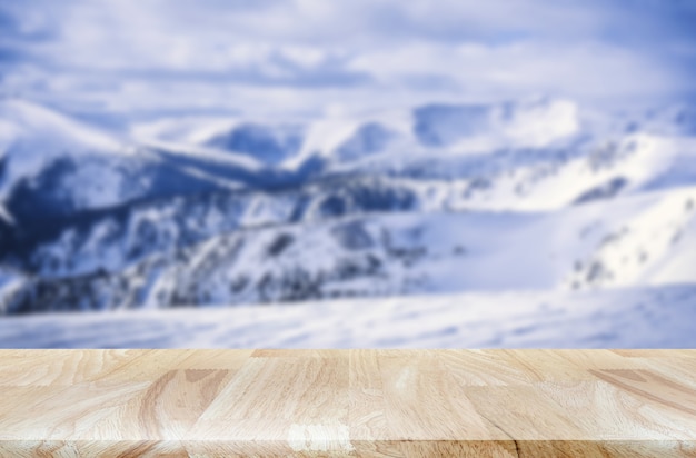 snow mountain range with lite wooden table product display