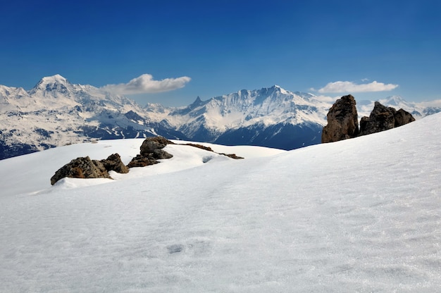 Snow on mountain in winter under blue sky 