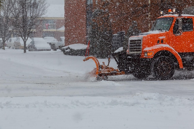 Photo snow plow doing removal after a blizzard in suberb