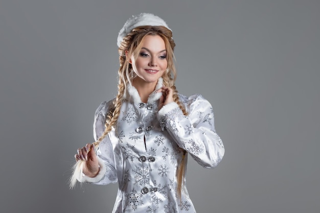 The snow queen a beautiful young woman in a fabulous fur coat of silver color a character in a winte...