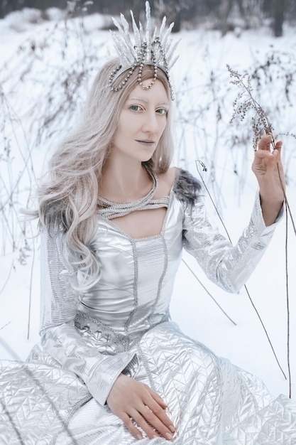 Snow Queen cosplay in the winter forest background Art photo