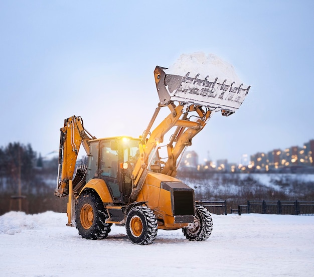 snow removal in the park with an excavator