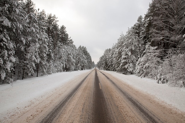 Snow on the road. Traces of cars were printed on the surface