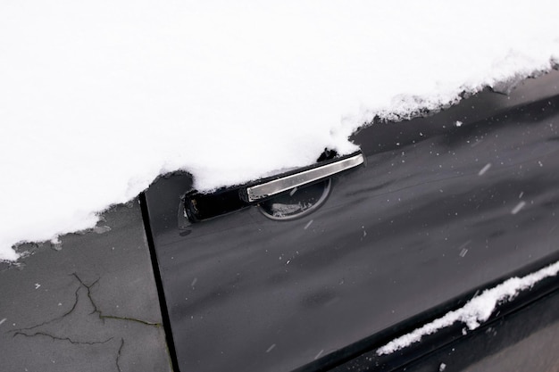 Snow on side door of the car