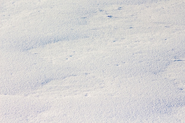 Snow texture. surface of the earth is unevenly covered with snow