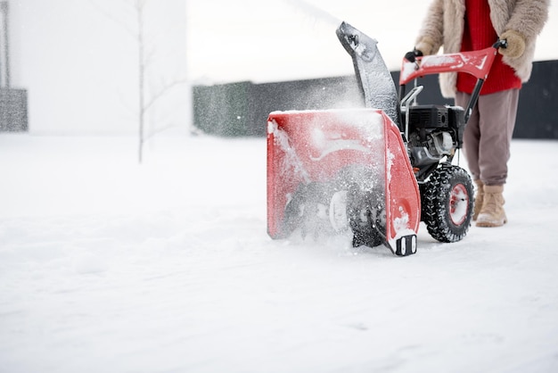 Snow thrower machine in work