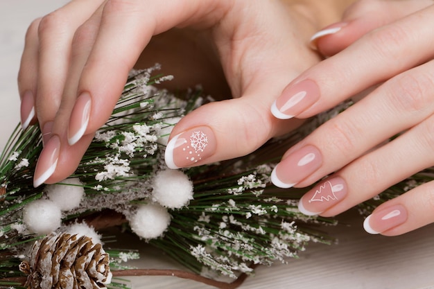 Snow White manicure on female hands. Winter nail design. Picture taken in the studio on a background of wool.