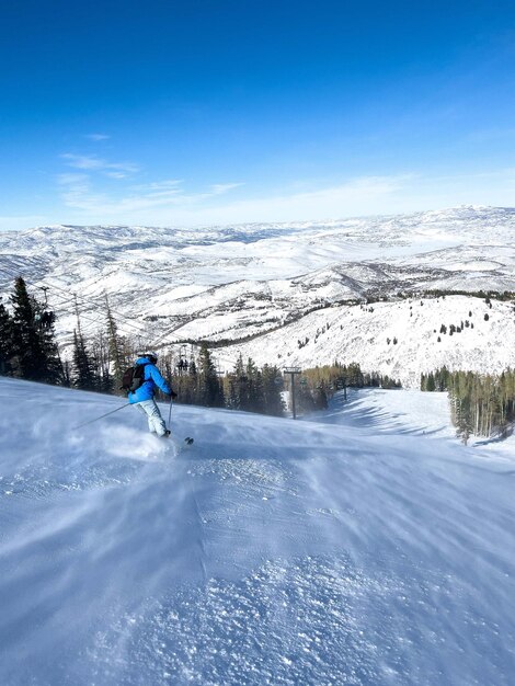 Snowboarder makes a jump on speed slope