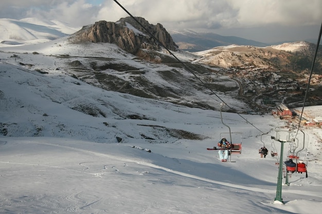 Snowboarder riding the cable car up the mountain