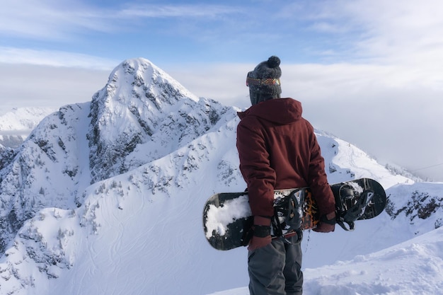 Snowboarder on top of the Mountain