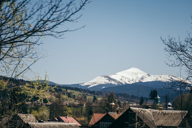 Snowcapped mountain on the horizon and mountain villages