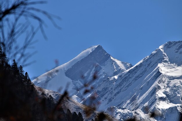 Snowcapped mountains against clear blue sky