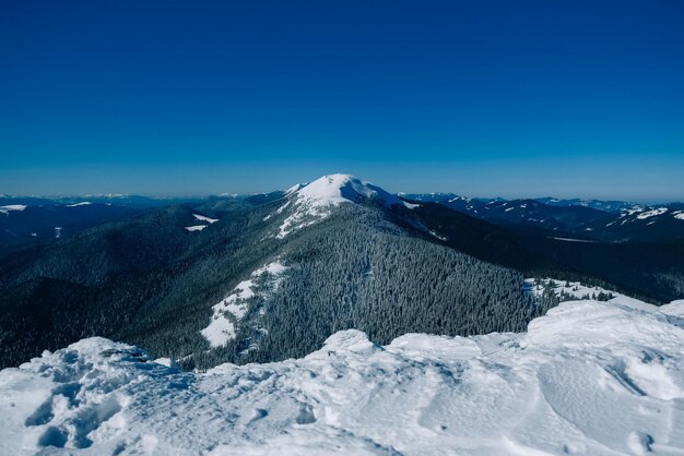 Snowcapped mountains on a background of blue sky