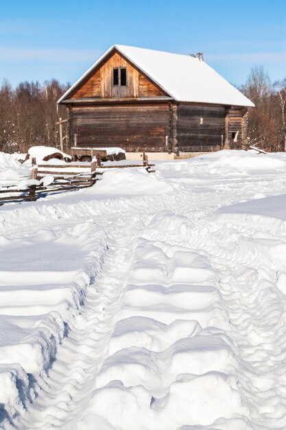 Snowcovered road in village in sunny day