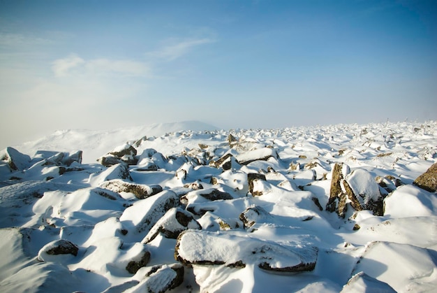 Snowcovered stones on the top of the mountain