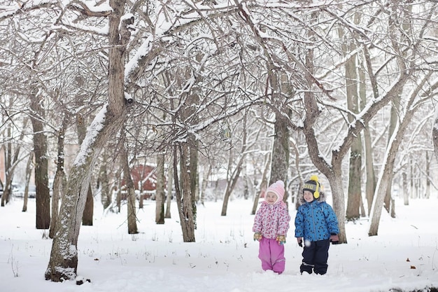 Snowcovered winter park and benches Park and pier for feeding ducks and pigeonsFamily on a walk in the snow covered the park