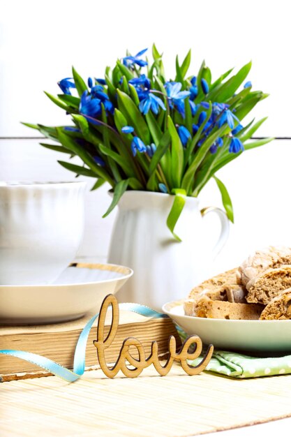 Snowdrops in a vase on a table on a white background