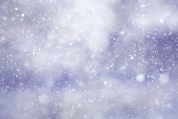 Snowfall texture of snowflakes on blurred background