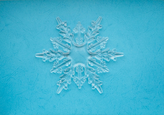 Photo snowflake on blue. flat lay