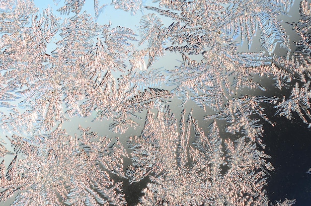 Snowflakes frost rime macro on window glass pane colorful ice on the window surface natural